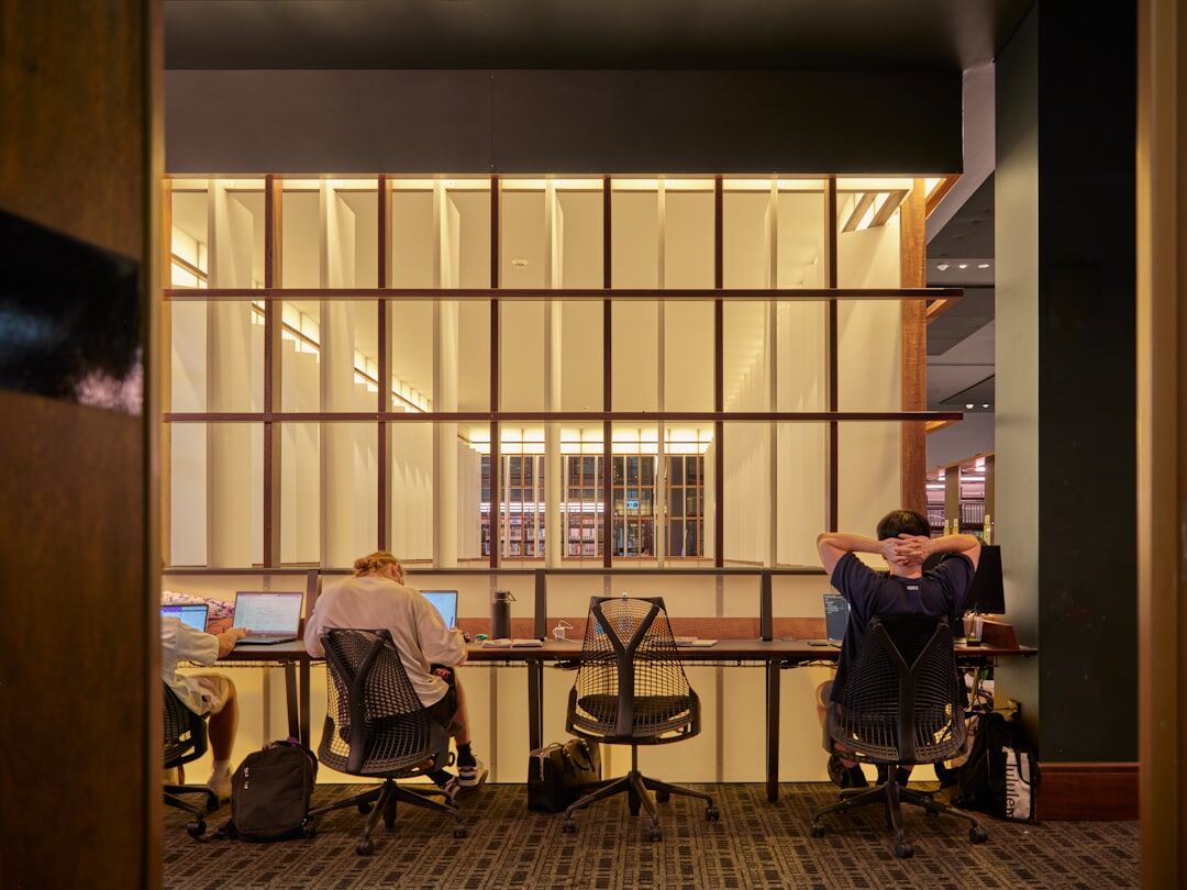 Modern newsroom office with people working at desks